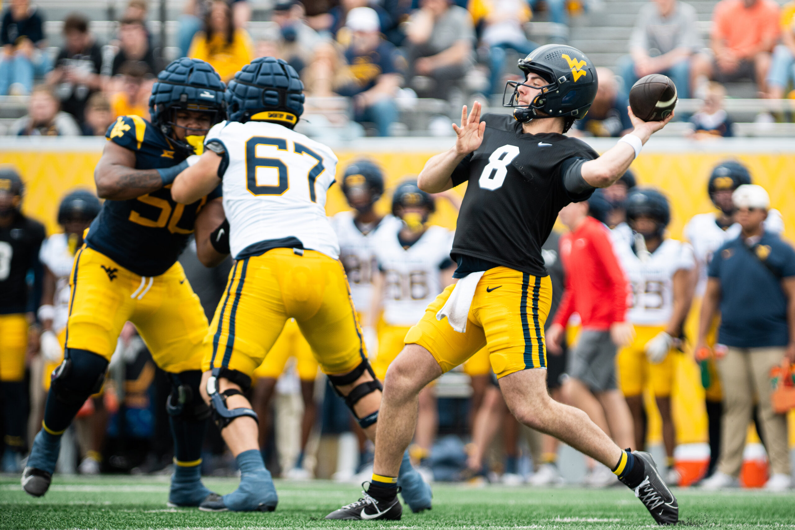 Rich Rodriguez won't tip hand, WVU's quarterback battle continues in Gold-Blue Showcase